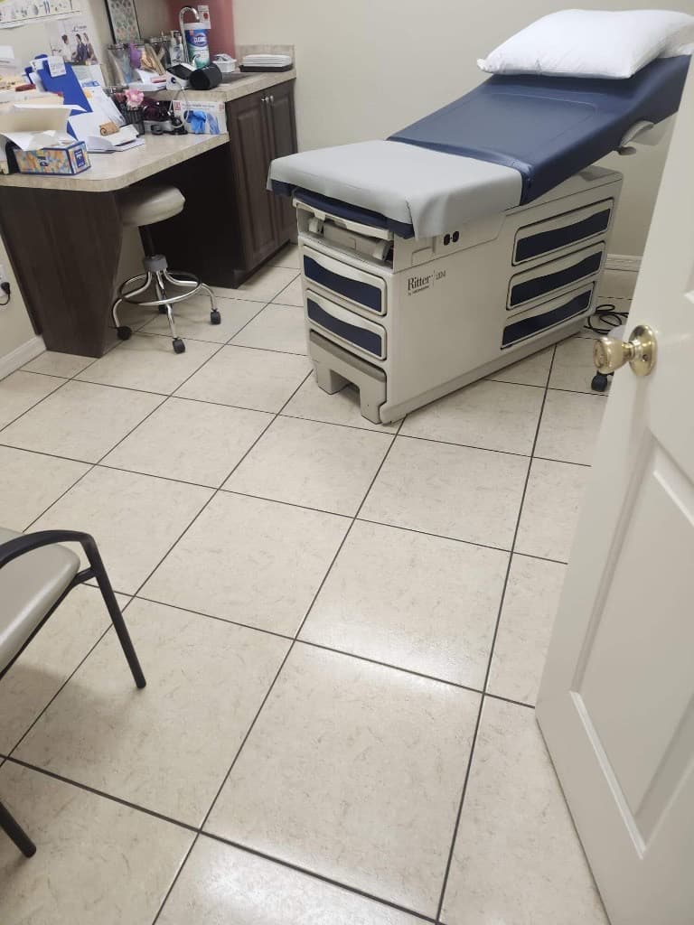 Immaculate commercial restroom with polished tile floors and well-maintained fixtures