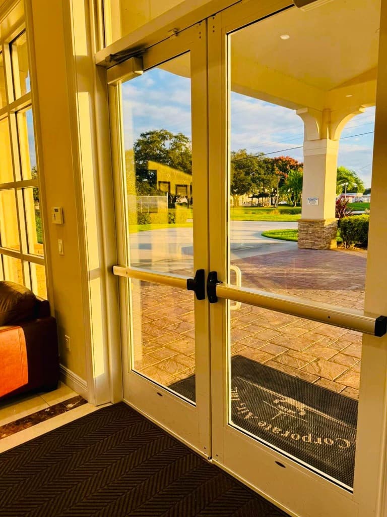 Clean commercial glass entrance doors with a bright exterior view